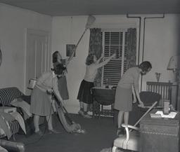Alpha Chi Omega members cleaning