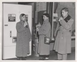 Students drinking by a Cornell milk dispenser.