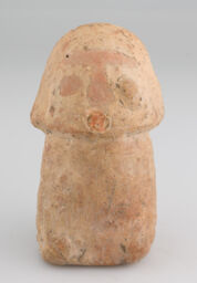 Small hollow figurine with roughly flat circular base, modelling of lower limbs head, face and coronal arch