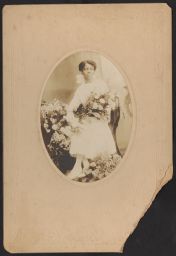 Woman in white dress holding flowers