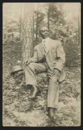 Man seated near tree