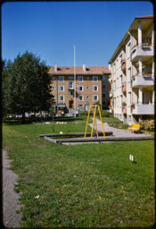 Play area behind two three-story residential buildings (Haaga, Helsinki, FI)