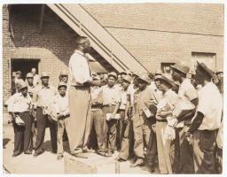 Jerome Holland addressing a group of workers