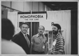 Three people at the National Gay Task Force's display at the 1973 APA Convention
