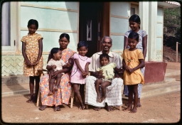 Parents and children in forecourt of new dwelling