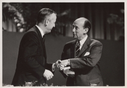 Cornell president James A. Perkins (left) shaking hands with Adlai Ewing Stevenson II at Centennial celebration