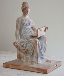 Terracotta figurine of woman seated with writing tablet