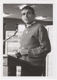 Daniel Berrigan speaking at a podium