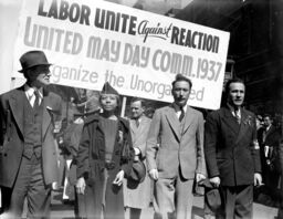 Edith Ransom and Charles Zimmerman (center) of ILGWU Local 22 march with others in the 1937 May Day parade.