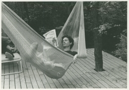 Man reading newspaper in hammock on Fire Island trip