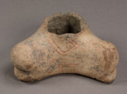 Basal fragment of polychrome rounded crescent based figurine