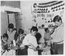 School boys work in machine shop
