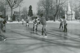 Students playing broomball on Ormsby Lake