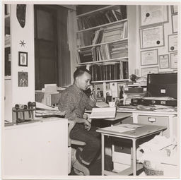 William Stringfellow on the phone at his desk