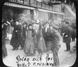 "Going out for better conditions." Group of men and women marching in the street
