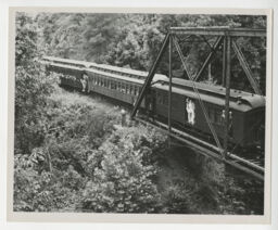 Tweetsie locomotive and cars on ET&WNC crossing a bridge over the Doe River