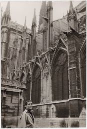 Daniel Berrigan smiling in front of a cathedral