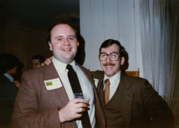 Two men in suits at a party