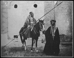Armed man on horseback, accompanied by a Bedouin man