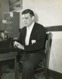 "L" Club student at typewriter