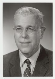 Portrait photograph of Prof. Donald Jay Grout (wearing a striped suit).