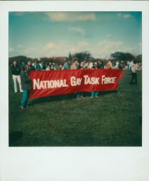 Marchers behind a National Gay Task Force banner at a gay pride parade