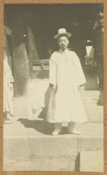 [Korean scholar posing on stone animal at Yi king's tomb]