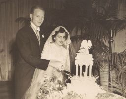 Phyllis and Archie Ammons cutting their wedding cake