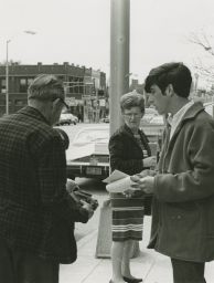 Student distributing fliers in downtown Appleton