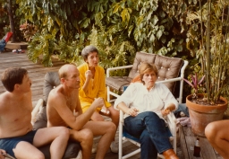 Group of people talking by poolside