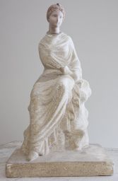Figurine of Woman in white dress sitting on rock