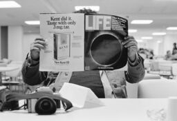 Unidentified man reading Life Magazine