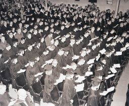 Graduates standing for Commencement