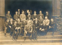 Physics Department staff and graduate students, circa 1906, seated on the steps of Randall Morgan Laboratory, group portrait