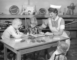 Student nurse, working with children in a play area