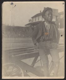 Boy leaning against cart