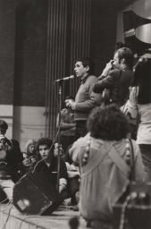 Daniel Berrigan in front of microphone