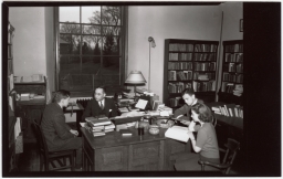 Cornell Classics Professor Harry Caplan at desk with three students