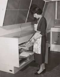 MIss Barbara Kenrick removes Silver From a Tray