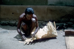 Householder making a winnowing basket from cane
