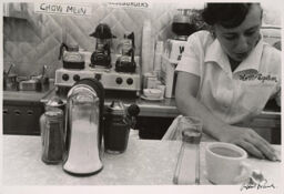 [Woman behind lunch counter]