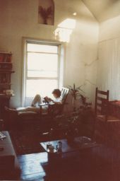 Photograph of Lindsay Cooper reading by a window