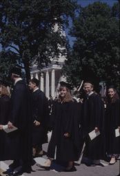 Students walk during Commencement with Memorial Chapel in background