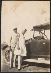Man and woman standing by car