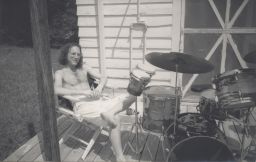 Photograph of Chris Cutler with drums outside