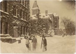 Men with skis outside Morrill Hall