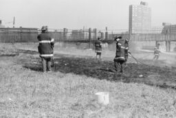 Firefighters in a vacant lot, Westchester Ave. and 3rd Ave.