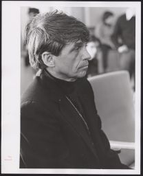 Daniel Berrigan in a black jacket