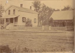 Houses and outbuilding with picket fence