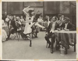 Photo of Irene Castle dancing in Patria, with other actors looking on.